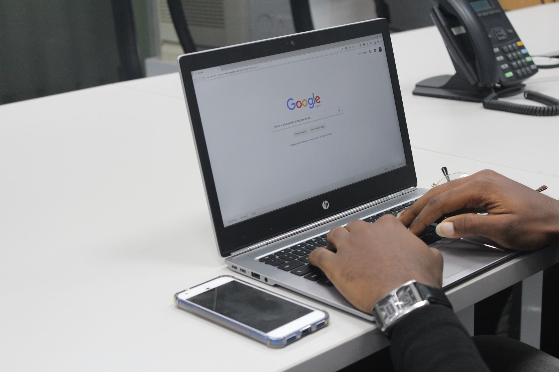 a person using a laptop computer sitting on top of a table